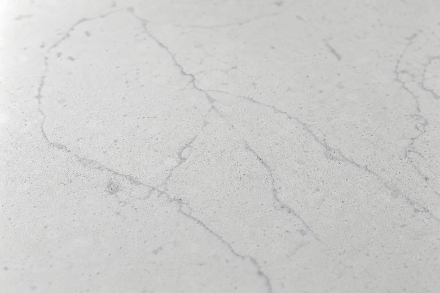 Stone quartz counter beside a built-in Sub-Zero protected during a Cupertino repair visit