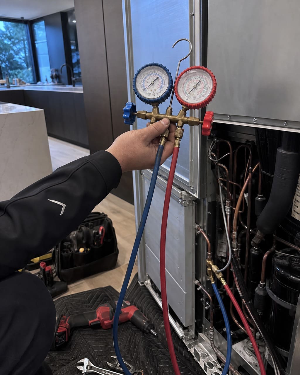 Refrigeration manifold gauges reading pressures on a built-in Sub-Zero sealed system during diagnosis in Cupertino